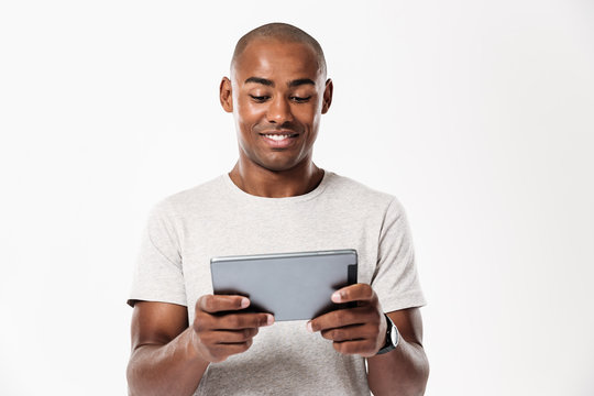 Smiling african man using tablet computer