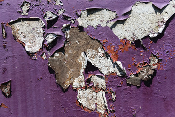 Close-Up Of Violet Wall With Cracking Layers Of Paint