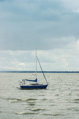 sailing boat alone on a cloudy day