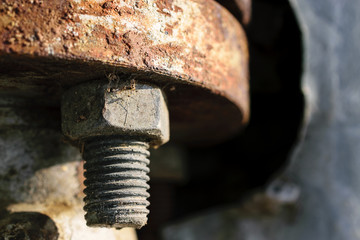 Extreme Close-Up Of Rusty Metal Bolt And Tightly Fastened Nut During Day