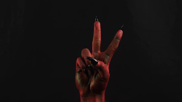 Peace gesture by devil hand.