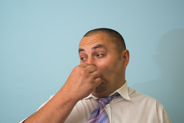 man closes his nose stinks