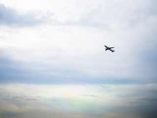 Air plane flying on cloudy sky