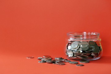 Coins in glass jar closeup texture blur background (Financial concept)