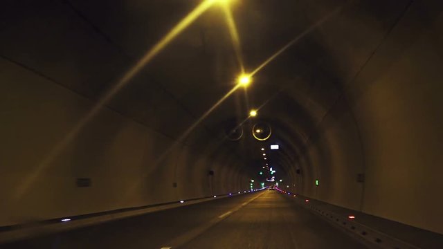 Time lapse footage of driving plate through tunnel. Car speeding through tunnel.