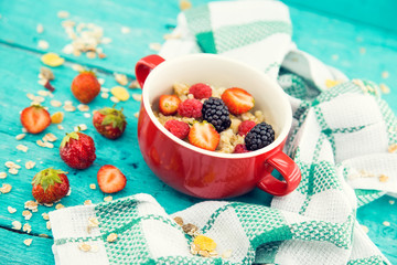 Bowl of oatmeal porridge with fresh berries: blackberry, strawberry and raspberry on . Healthy food for breakfast