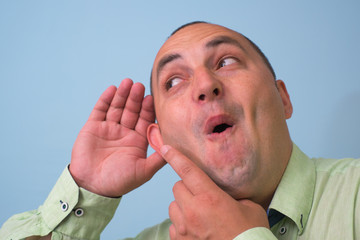 Overhears a man, tries to listen.