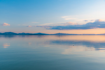 sunset over Lake Trasimeno in Umbria, with rippled water