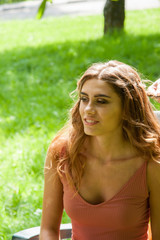 Naklejka premium Making a hair style for young girl outdoors at park.
