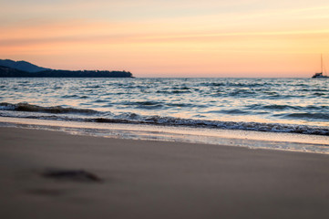 Soft waves on the sand at sunset. Selective focus.