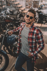 Fototapeta na wymiar motorcyclist in sunglasses with classic motorbike