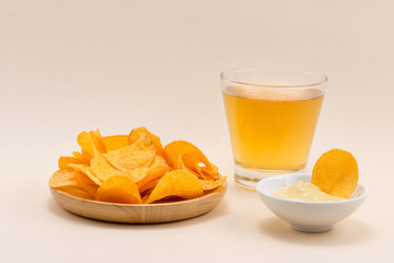 Cheese and onion potato chips with soft drink on table.