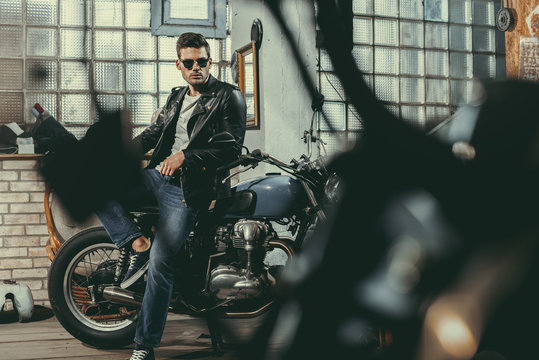 Handsome Biker In Workshop