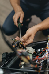repairing motorcycle in workshop
