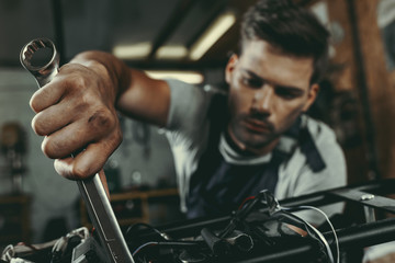 mechanic repairing motorbike