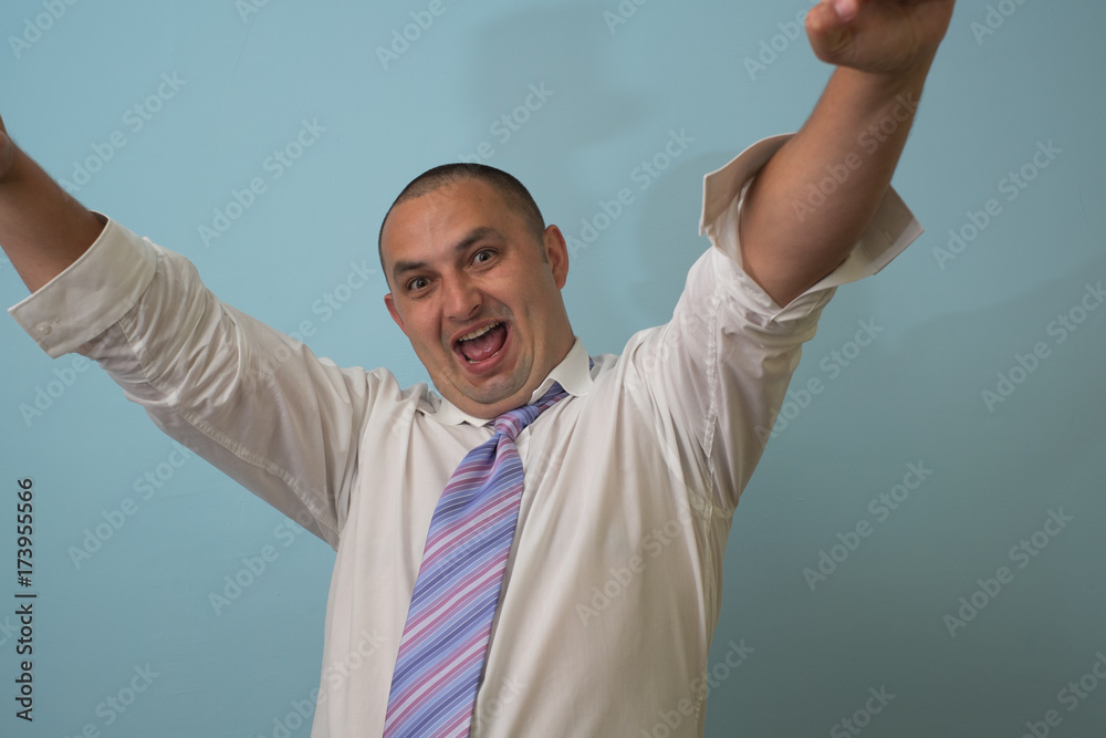 Wall mural excited happy successful man triumphing with raised hands