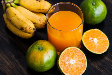 a glass of orange juice and fruit