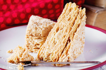 sweets and desserts, cakes and pastries, Napoleon with puff pastry, custard and a cup of black coffee on a light background