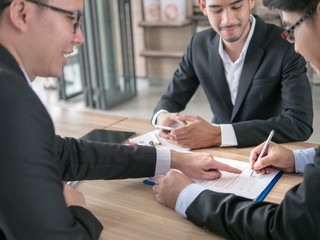 The selective and soft focused image of businessman is going to sign the contract in the business...