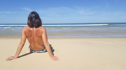 Portrait of young attractive woman having good time in the beach