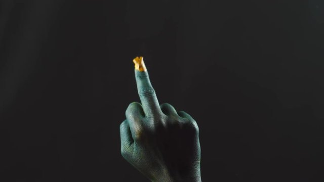 Green hand of troll makes fuck sign.