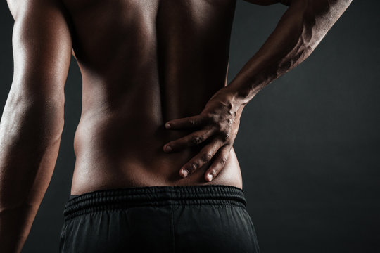 Cropped photo of young afro american man with back pain
