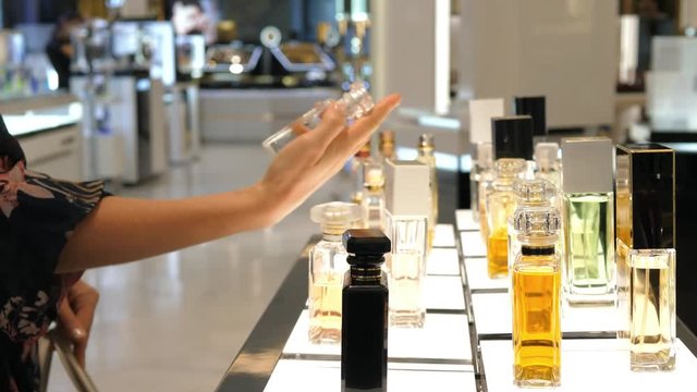 Woman Hand Choosing Luxury Parfume In Perfume Shop. Closeup. 4K. 