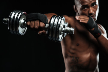Afroamerican boxer training with dumbbells