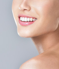 Beautiful face of young adult woman with clean fresh skin. Amazing smile, perfect teeth.