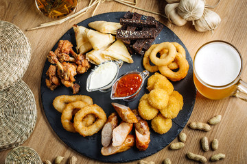 Fast food snacks composition with beer. Unhealthy junk food