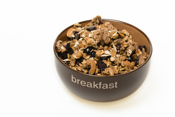 Bowl of whole grain granola isolated on white background