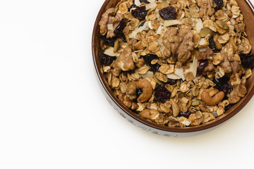 Bowl of whole grain granola isolated on white background
