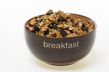 Bowl of whole grain granola isolated on white background