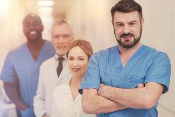 Fototapeta premium Handsome brunette crossing arms on chest