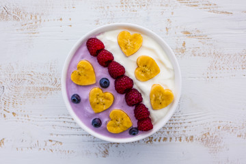 A bowl of healthy and delicious smoothie with  fresh berry fruit. 