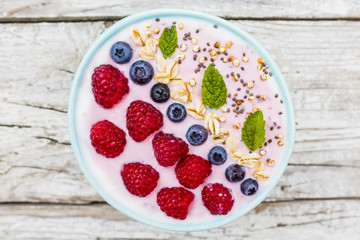A bowl of healthy and delicious smoothie with grains and fresh berry fruit. 