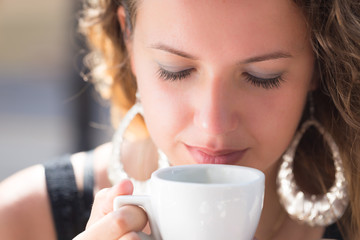 young woman portrait , drinking coffee in cafe outdoor in summer