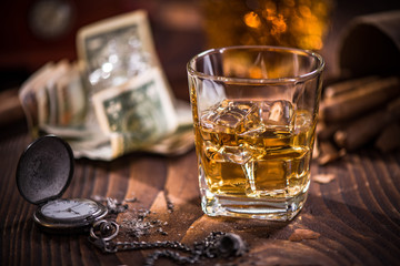 Luxurious vintage watch,money and glass of whiskey