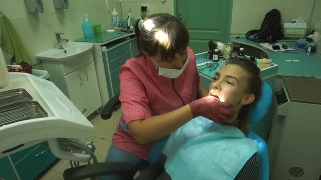 lovely young girl treats her teeth