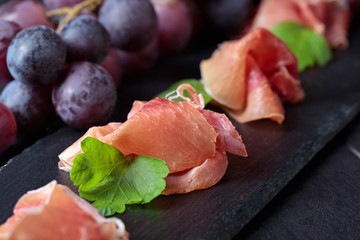 Prosciutto with parsley and grape.