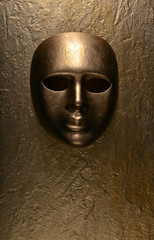 Carnival mask on a golden background.