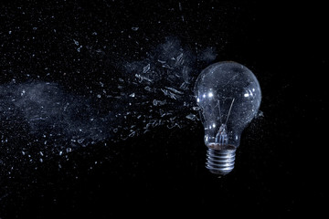  explosion of a bulb of an electric bulb, black background, nobody around. concept of fragility and danger. high speed photography.