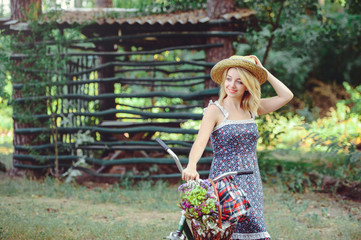 Obraz premium beautiful woman with a bicycle on nature, happy and healthy, healthy lifestyle