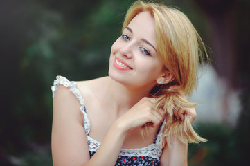 portrait of a happy woman on a picnic braided hair and smiling, togetherness with nature and a healthy lifestyle