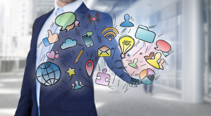 Businessman in front of a wall writing on hand drawn business interface - business concept