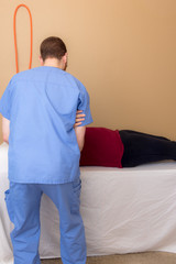 Physical Therapist Working with Patient - 173977960