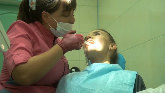 young attractive girl treats her teeth
