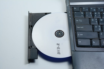 Obraz premium the DVD disc in tray of notebook computer