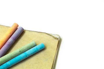 Education chalk put on brown book on white background