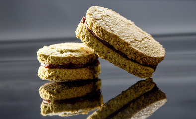 Famous dessert cake matcha dacquoise (French pronunciation) on reflective black background
